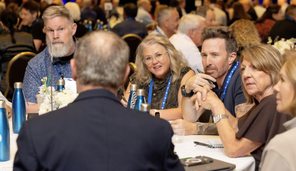 ProVisors group leaders listening and taking notes in a table discussion at ProVision 2026