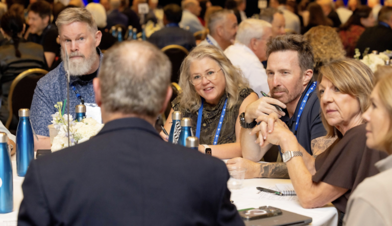 ProVisors group leaders listening and taking notes in a table discussion at ProVision 2026