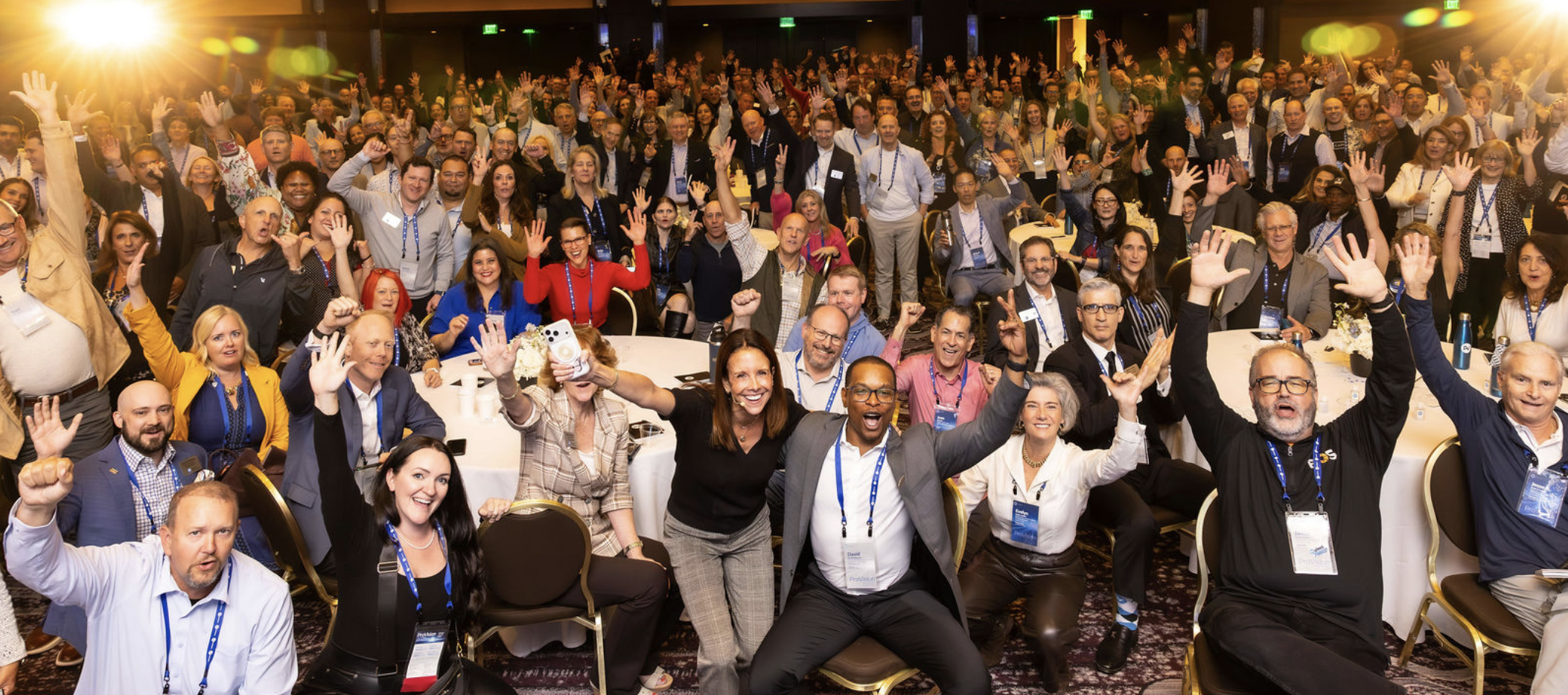 Large crowd of ProVisors group leaders cheering with arms raised in a hotel ballroom at ProVision 2026